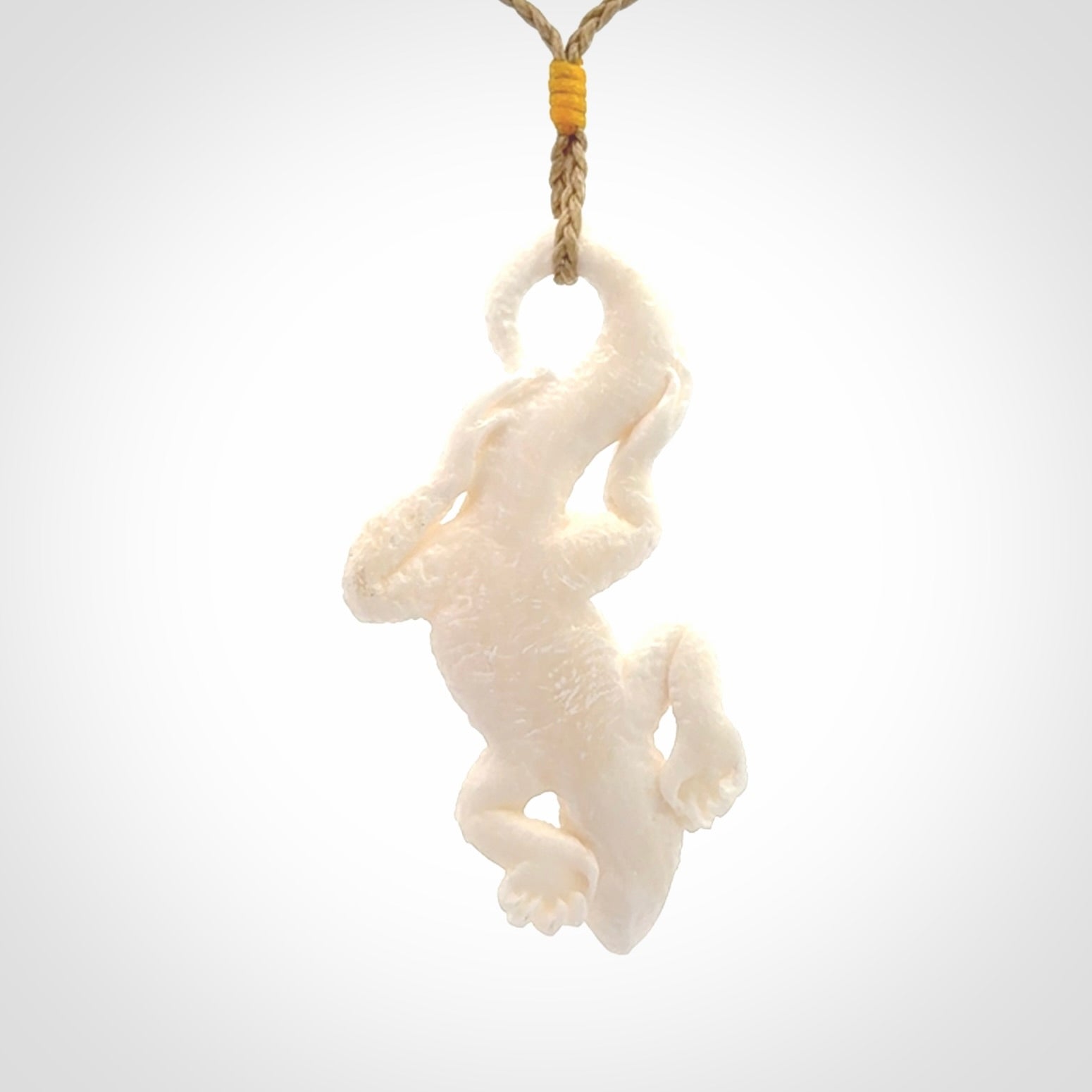 Hand carved bone Tuatara pendant.