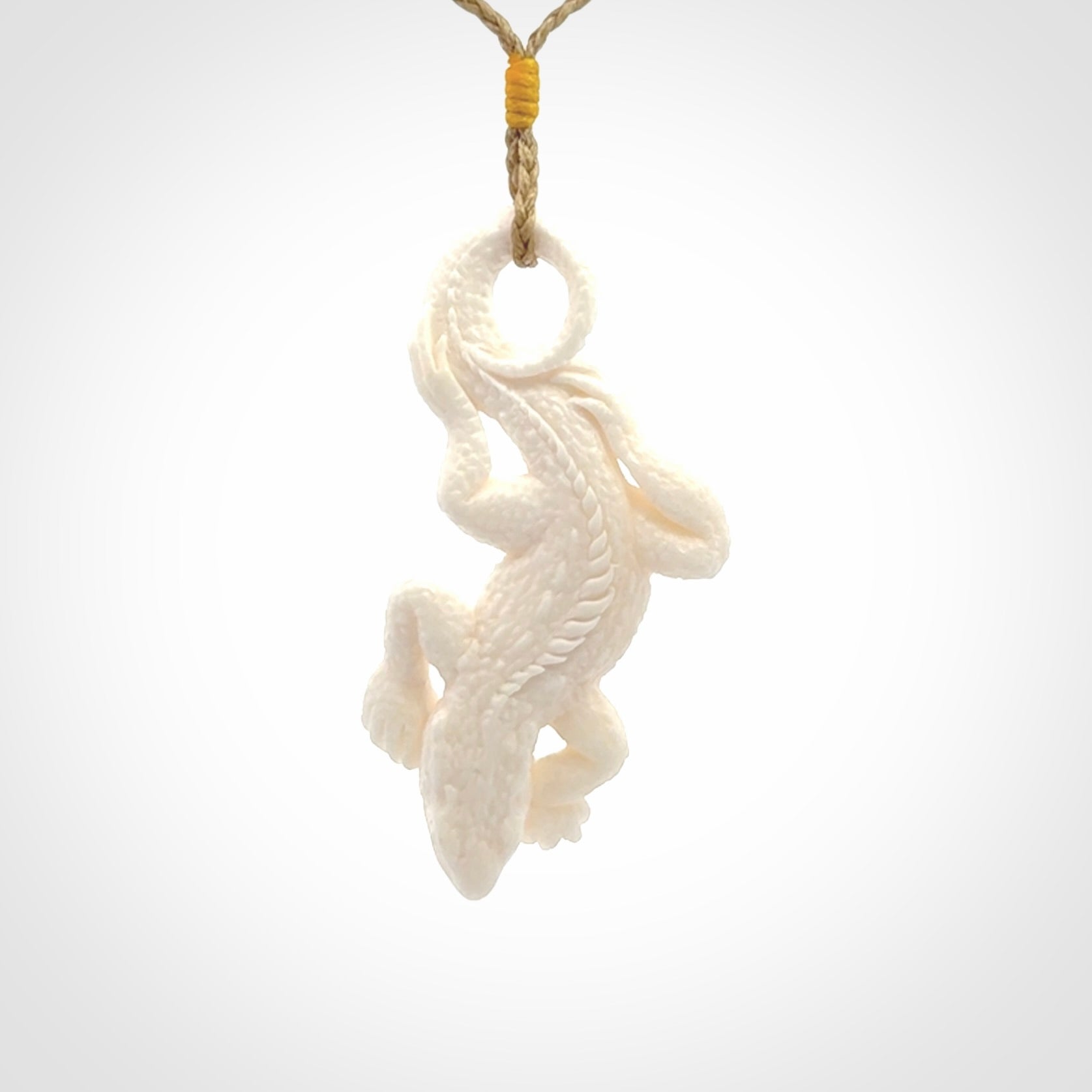 Hand carved bone Tuatara pendant.