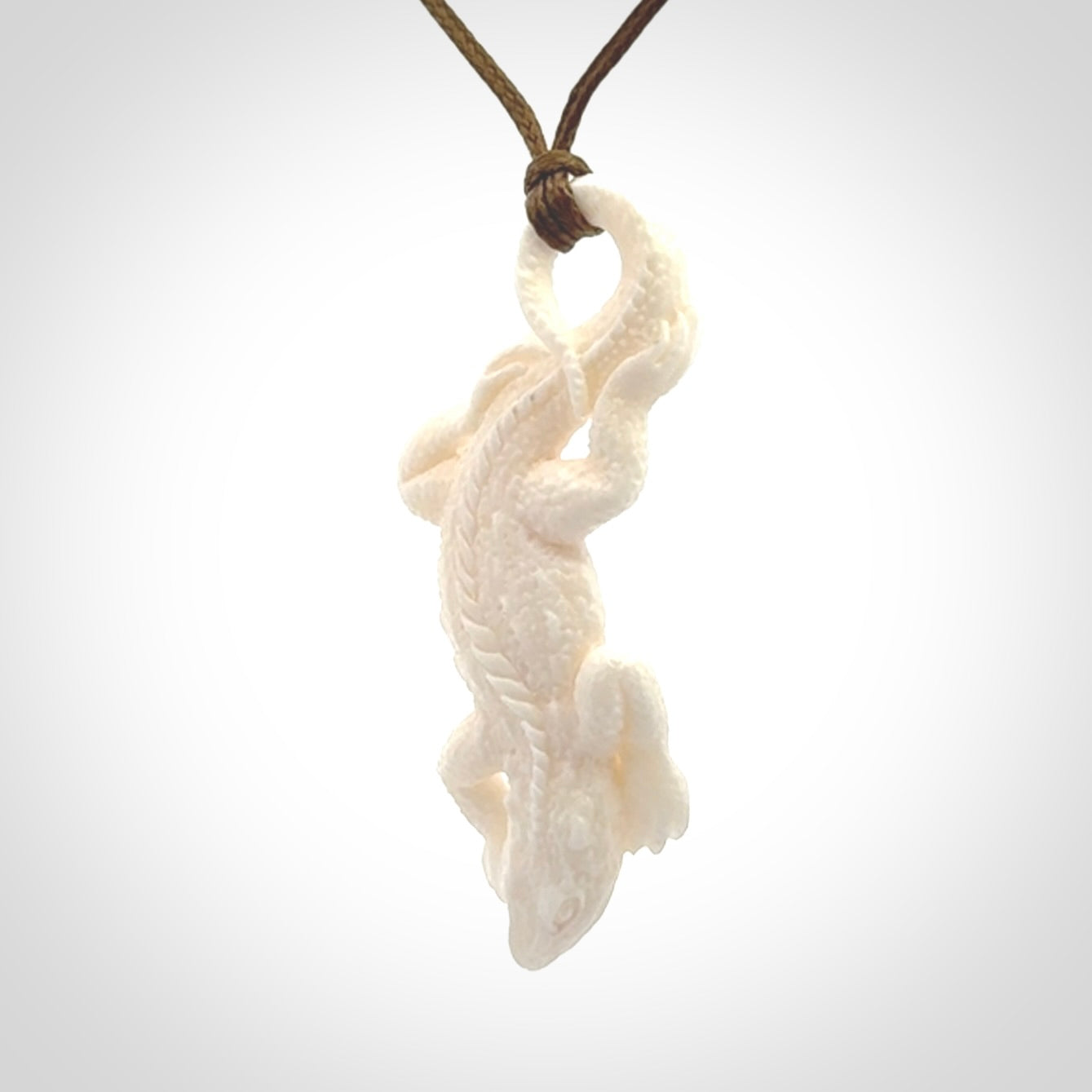 Hand carved bone Tuatara pendant.