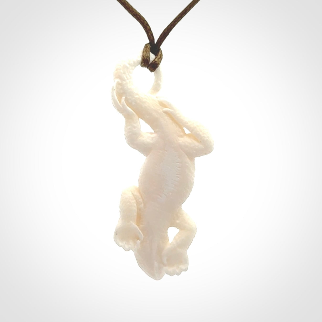 Hand carved bone Tuatara pendant.