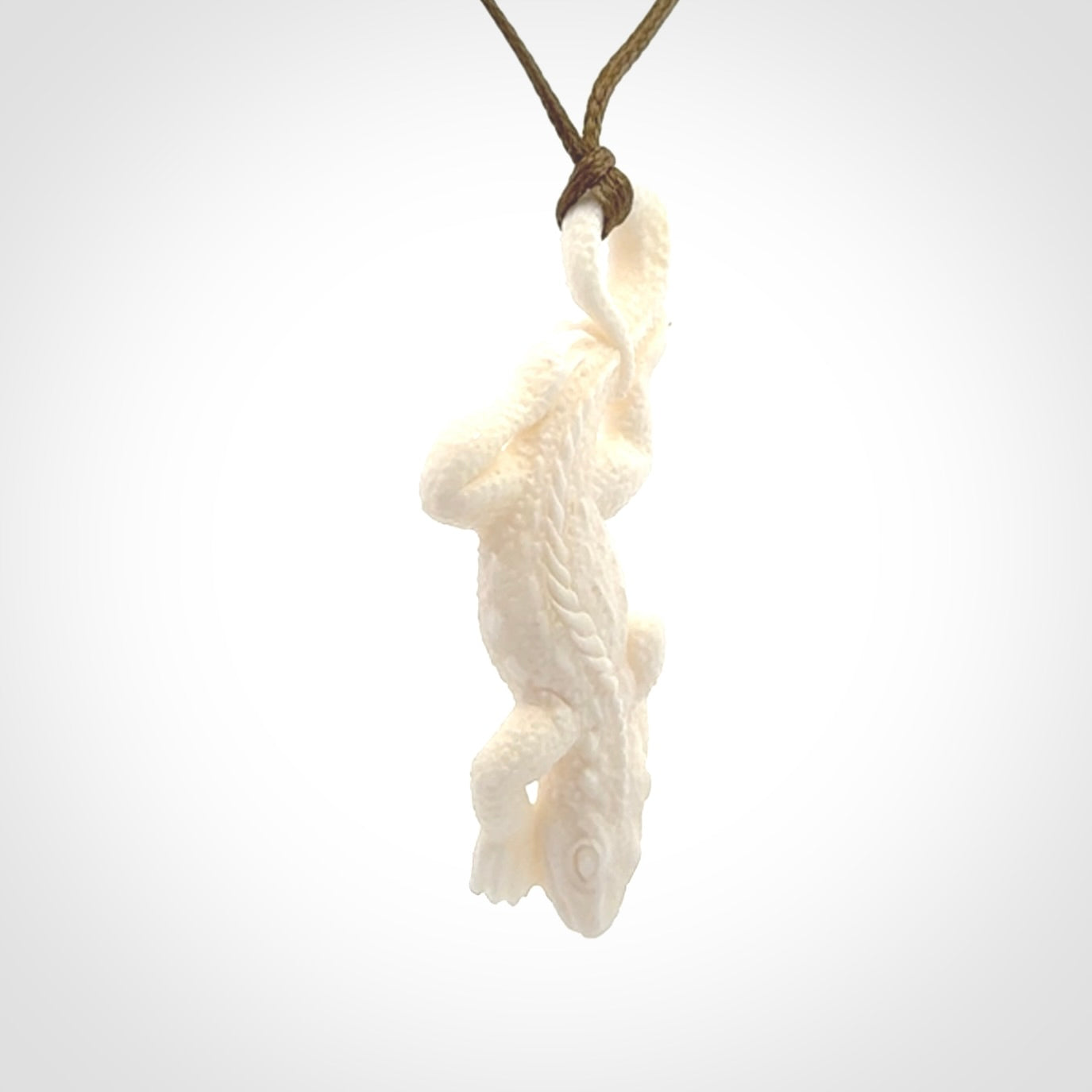 Hand carved bone Tuatara pendant.