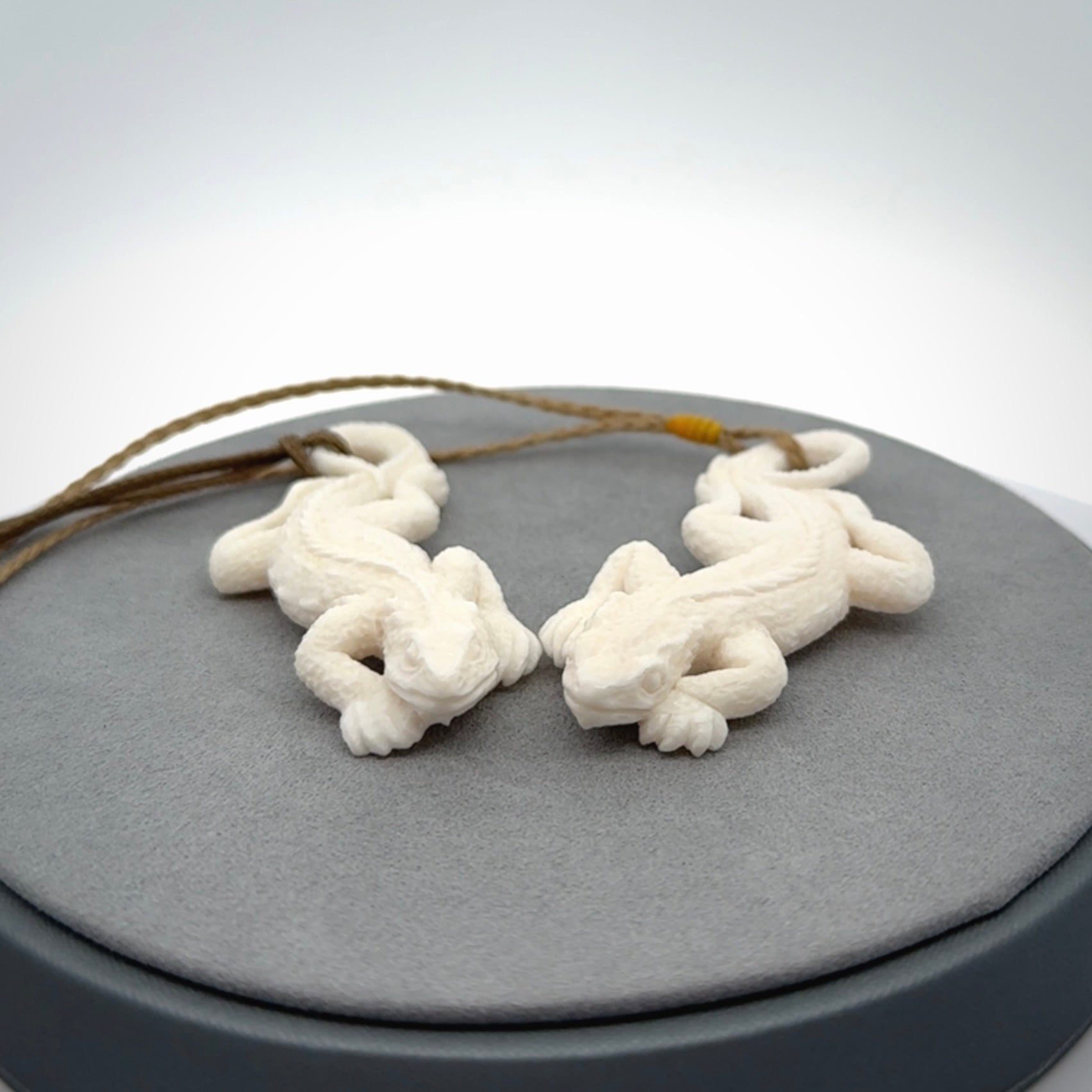 Hand carved bone Tuatara pendant.