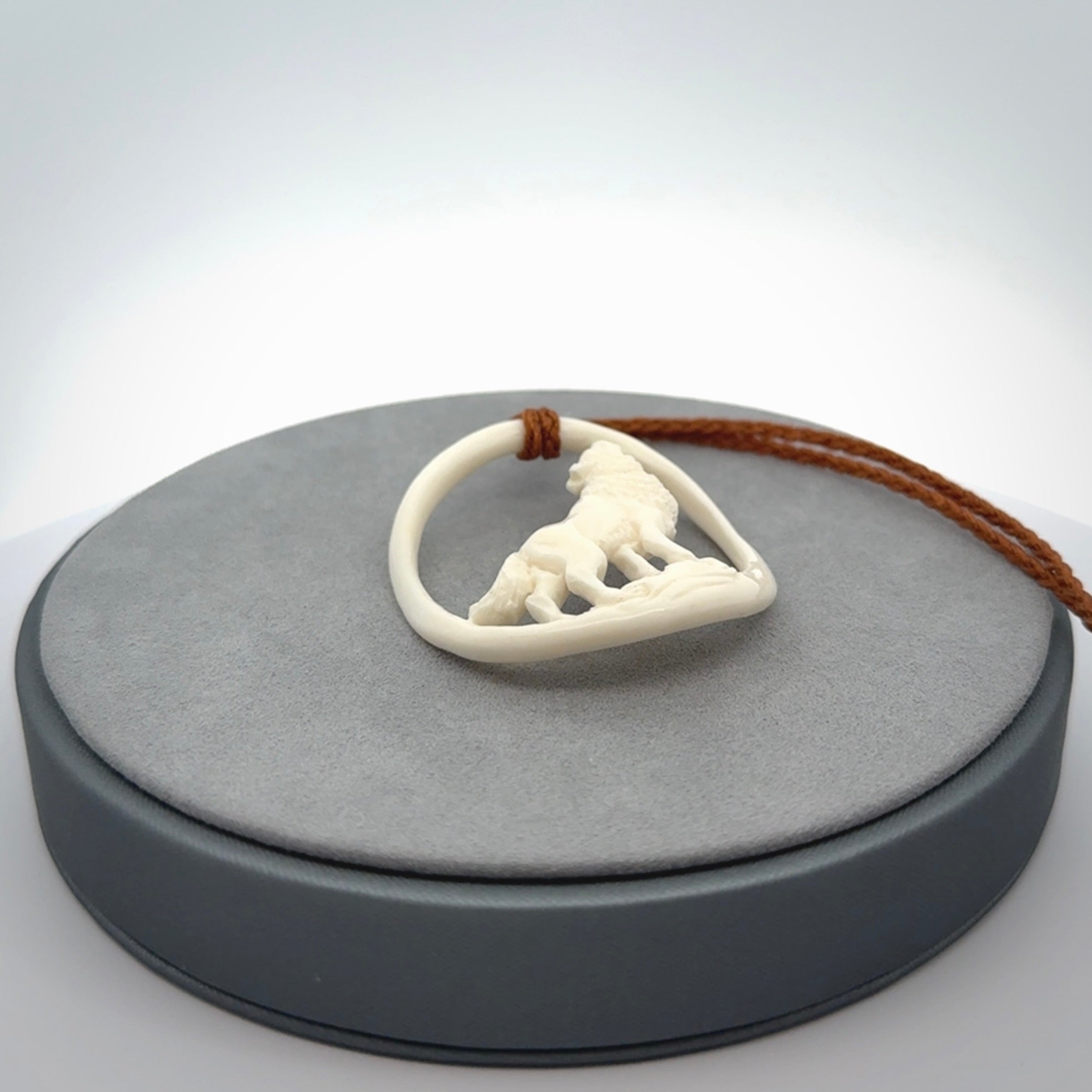 Hand carved bone wolf moon pendant.