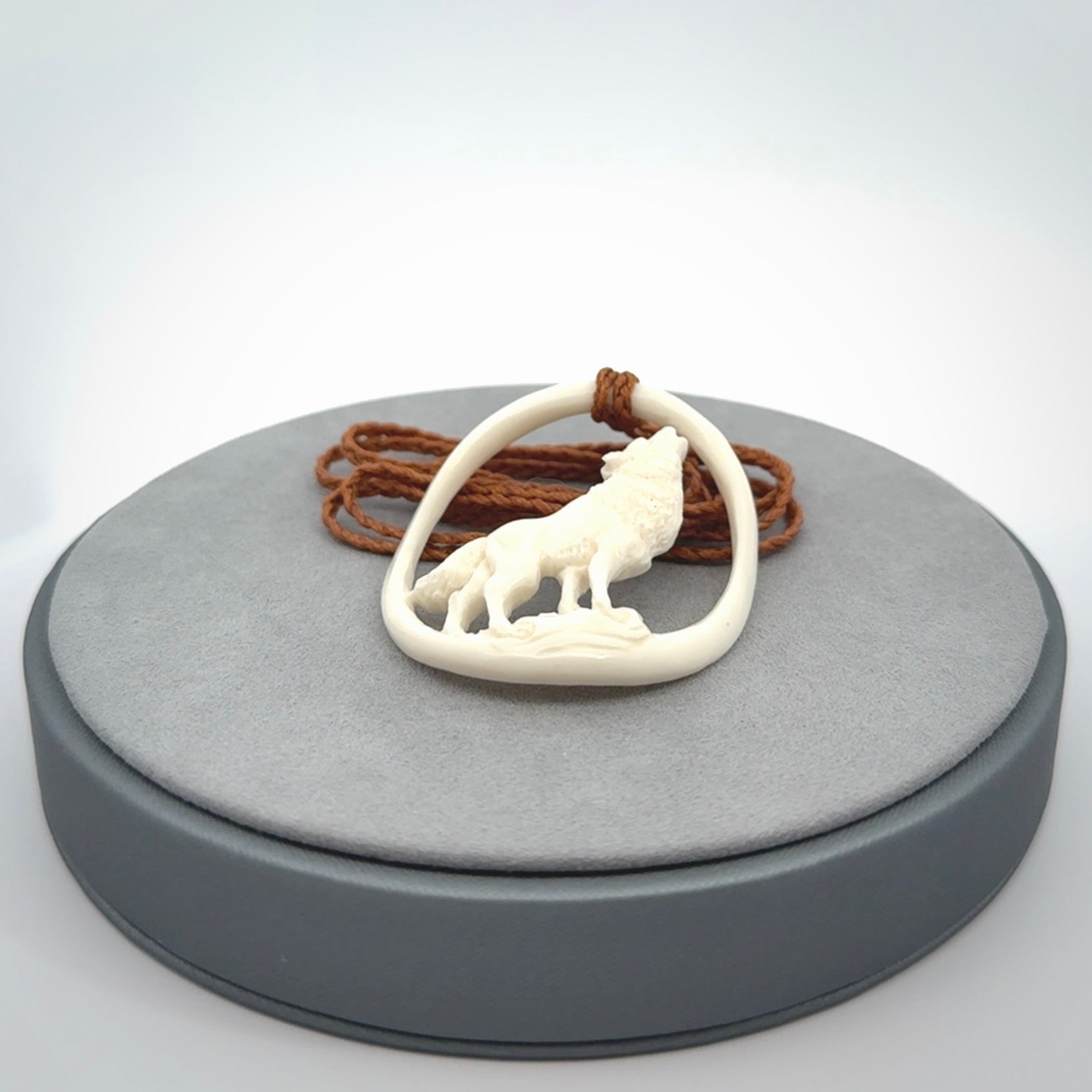 Hand carved bone wolf moon pendant.