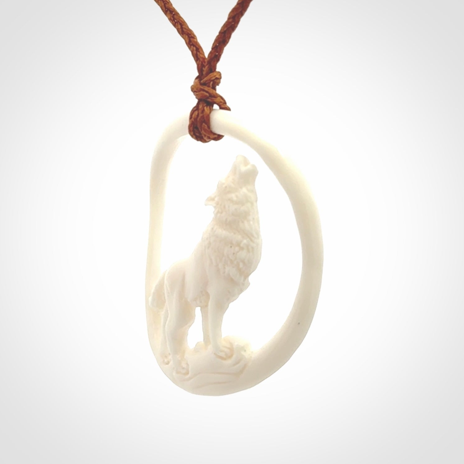Hand carved bone wolf moon pendant.
