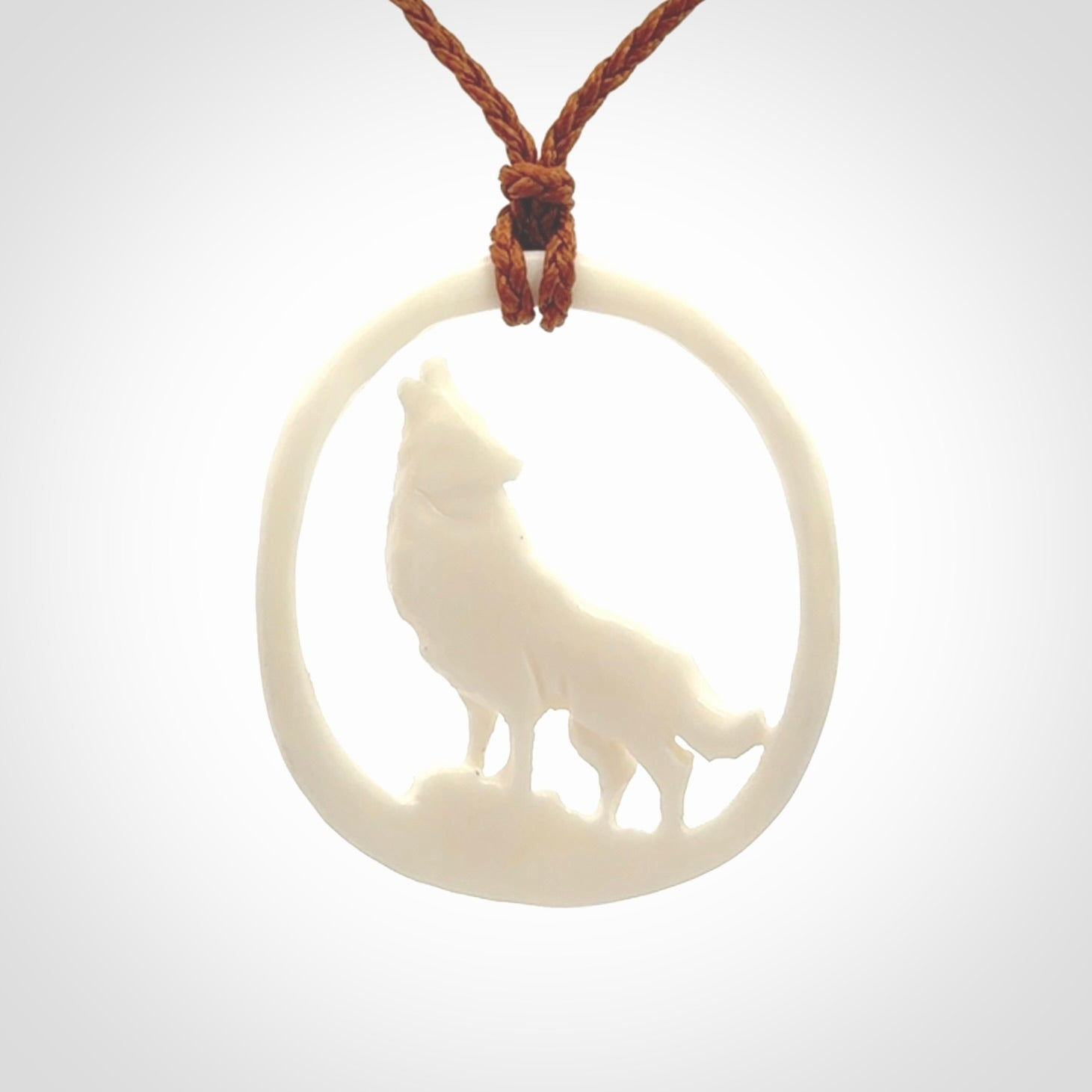 Hand carved bone wolf moon pendant.