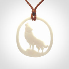 Hand carved bone wolf moon pendant.