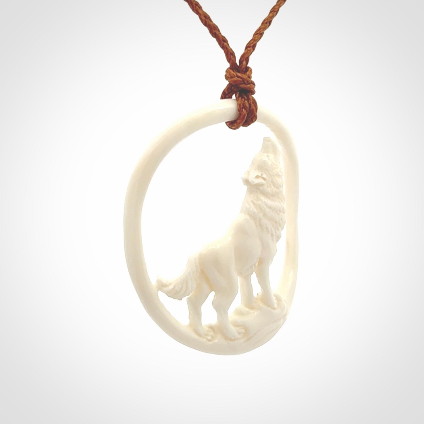 Hand carved bone wolf moon pendant.
