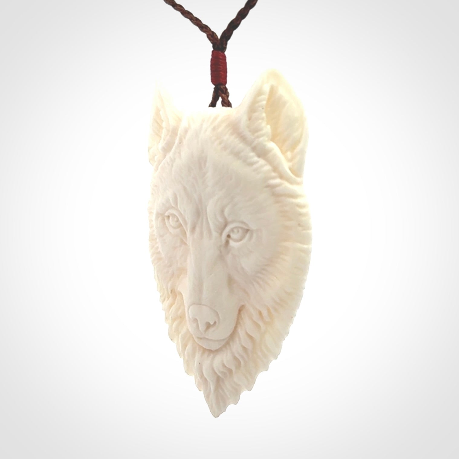 Hand carved bone wolf pendant.