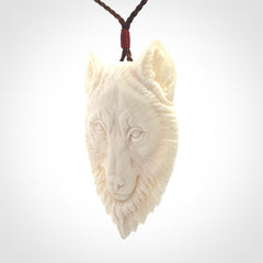 Hand carved bone wolf pendant.