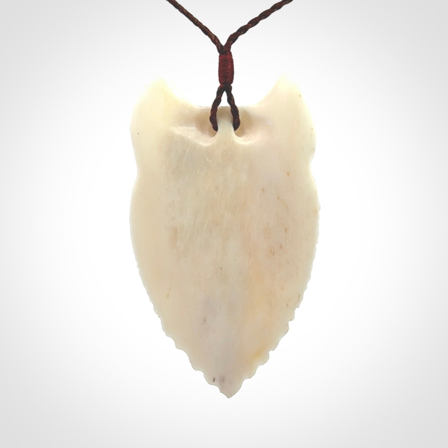 Hand carved bone wolf pendant.