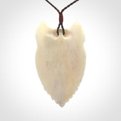 Hand carved bone wolf pendant.