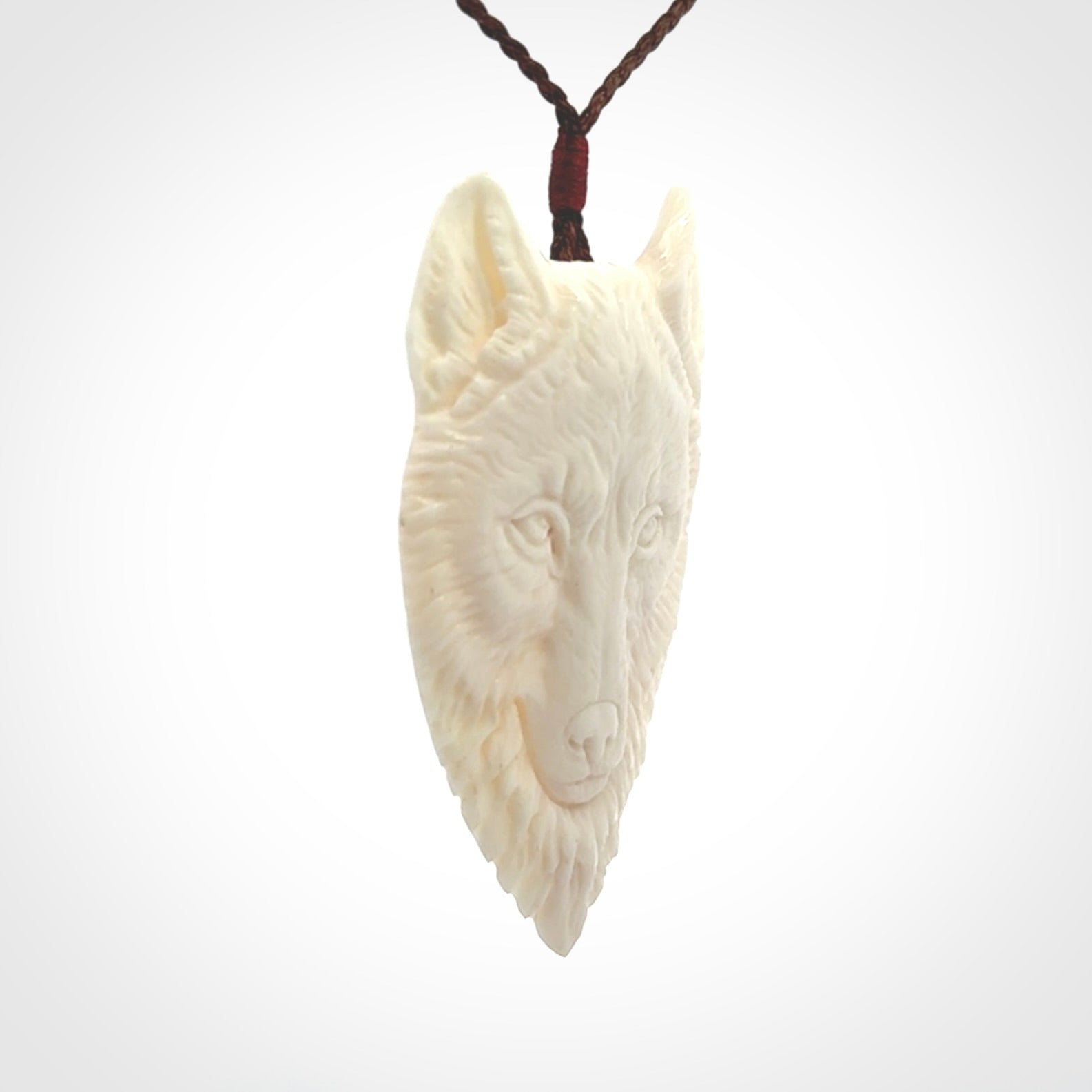 Hand carved bone wolf pendant.