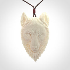 Hand carved bone wolf pendant.