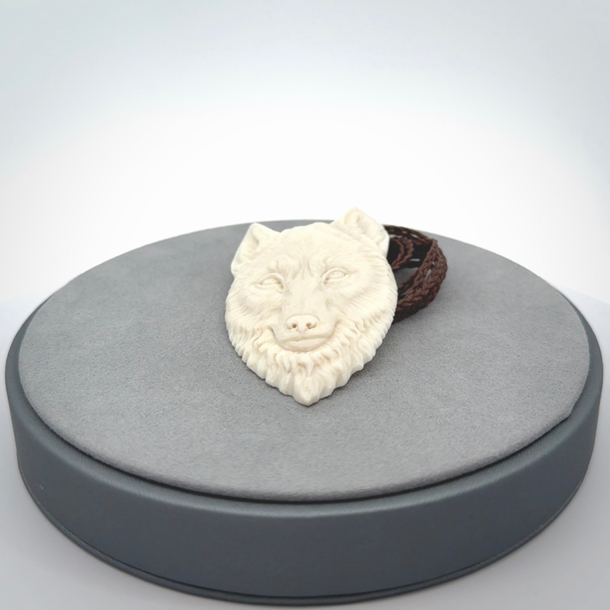 Hand carved bone wolf pendant.