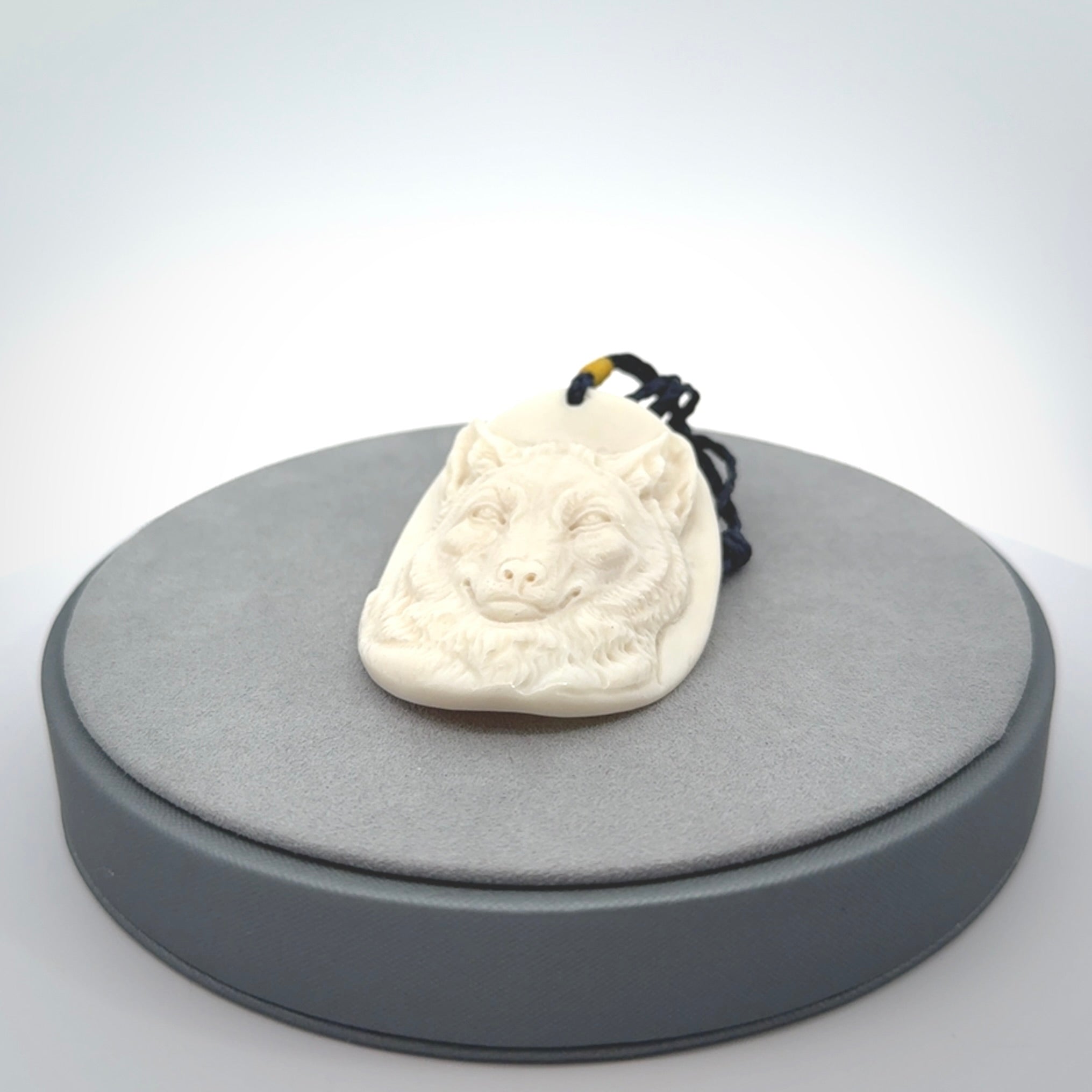 Hand carved bone wolf pendant.