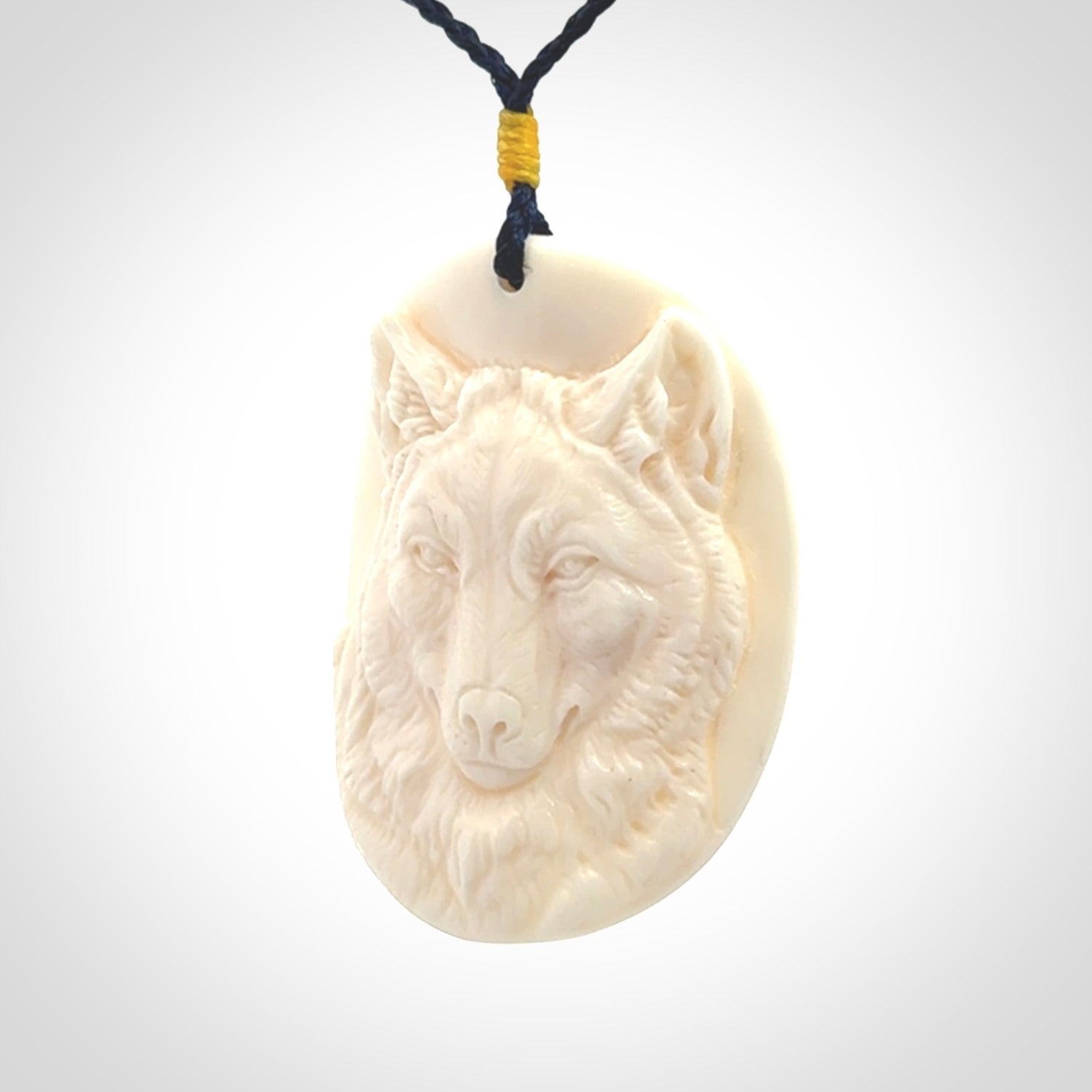 Hand carved bone wolf pendant.