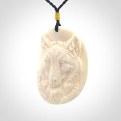 Hand carved bone wolf pendant.