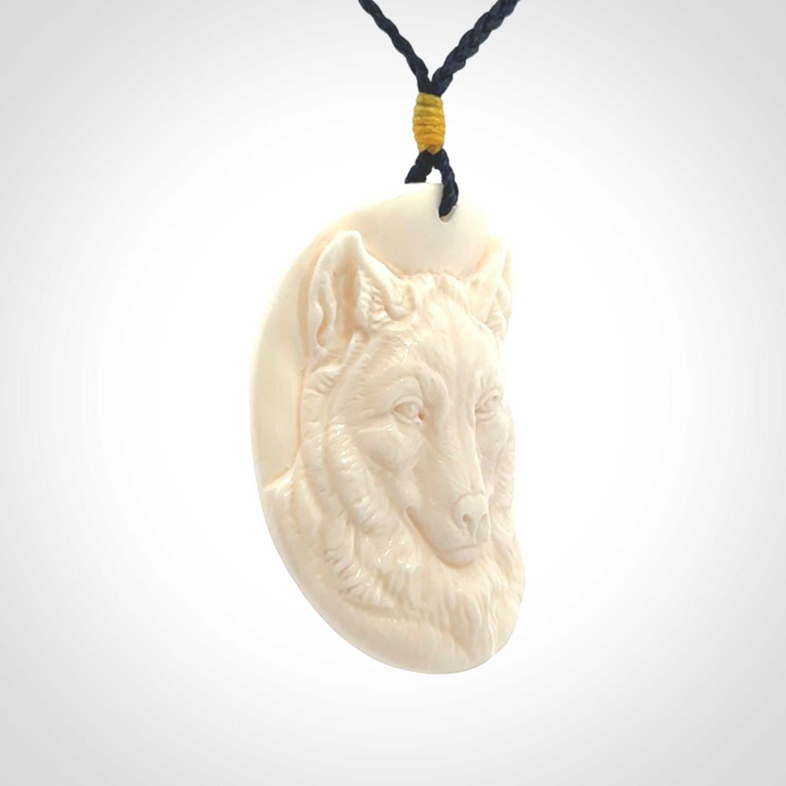 Hand carved bone wolf pendant.