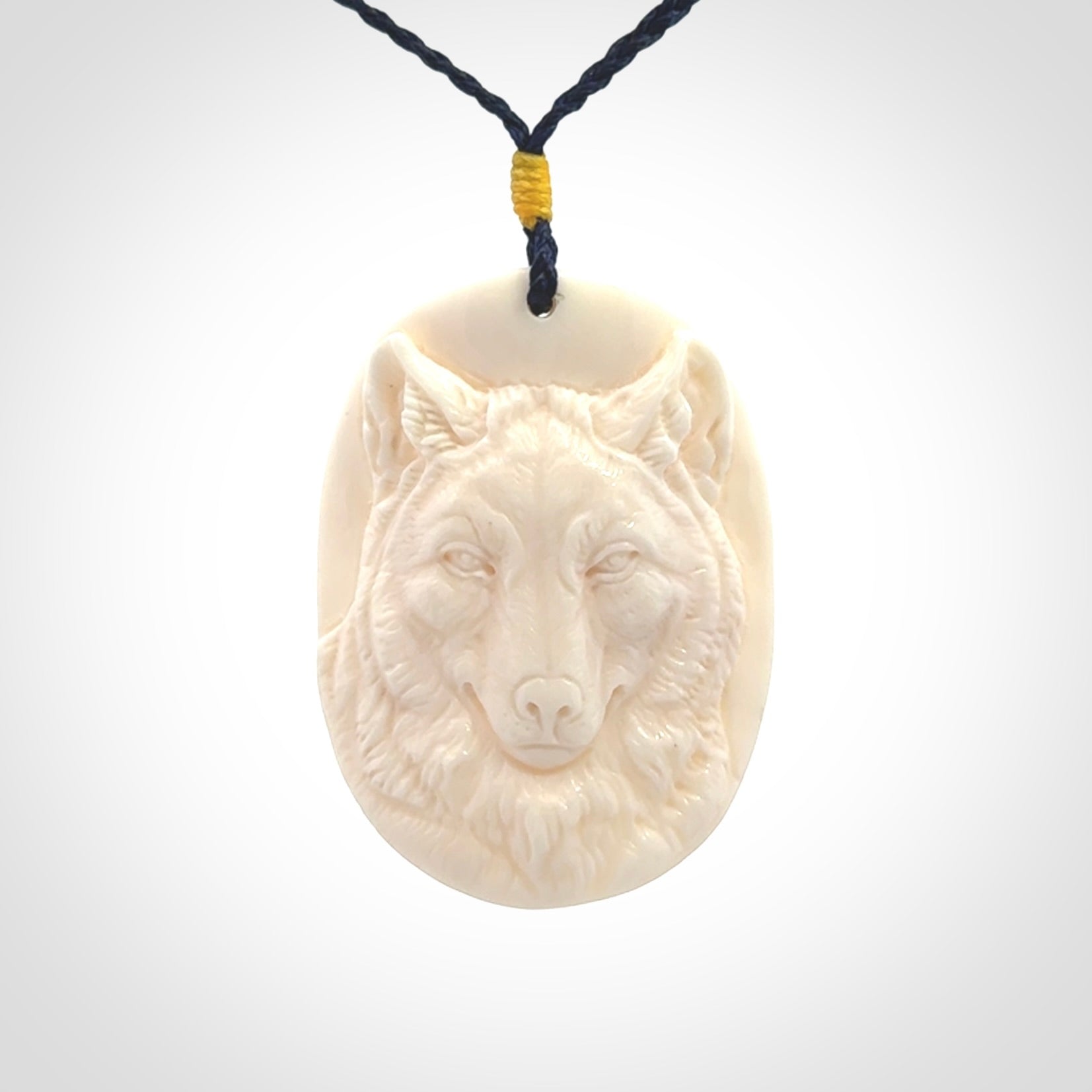 Hand carved bone wolf pendant.