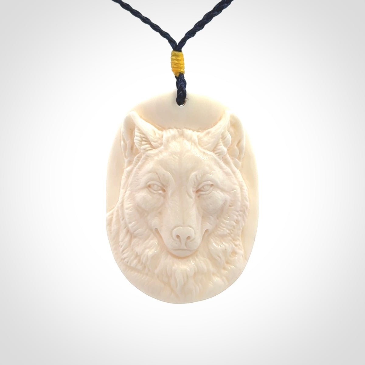Hand carved bone wolf pendant.