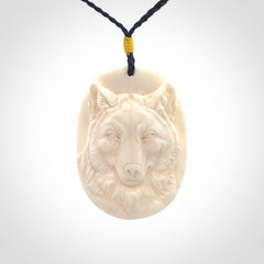 Hand carved bone wolf pendant.