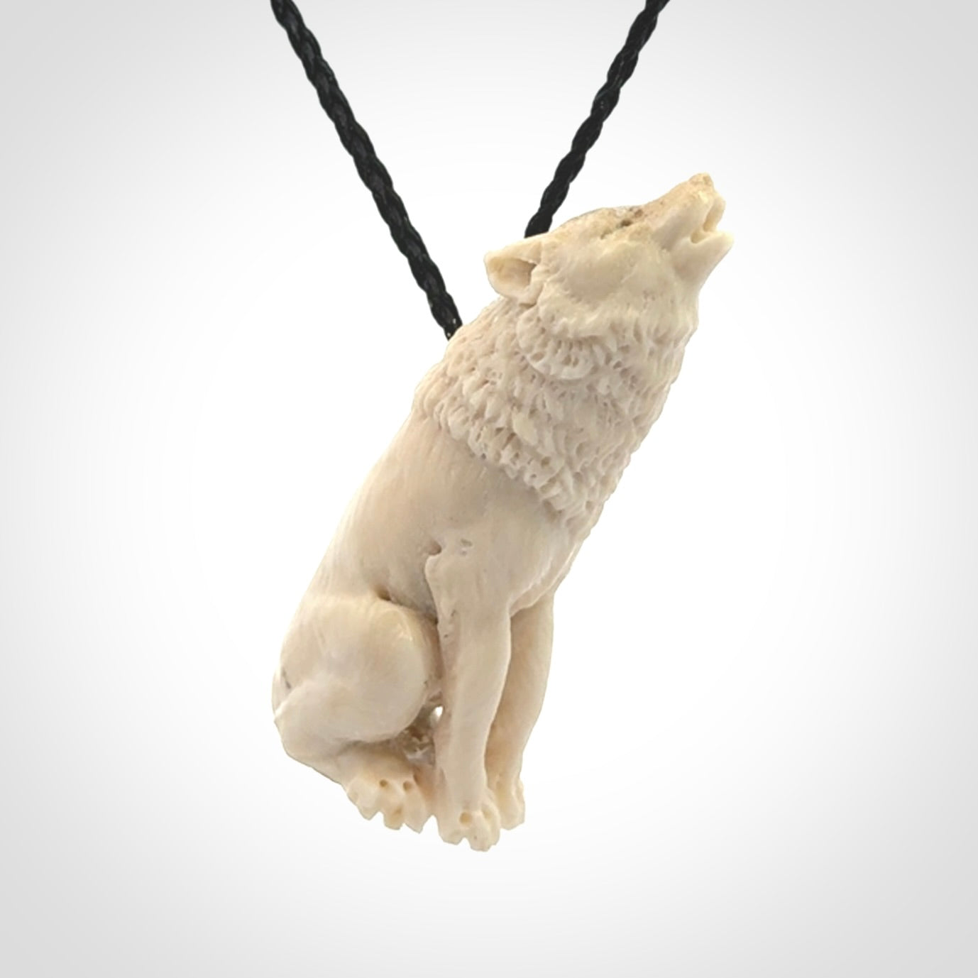 Hand carved bone wolf pendant.
