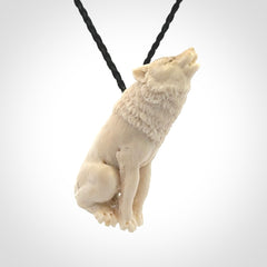 Hand carved bone wolf pendant.