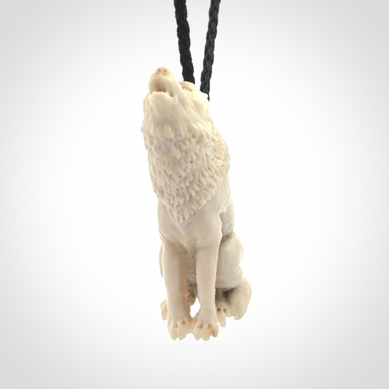 Hand carved bone wolf pendant.