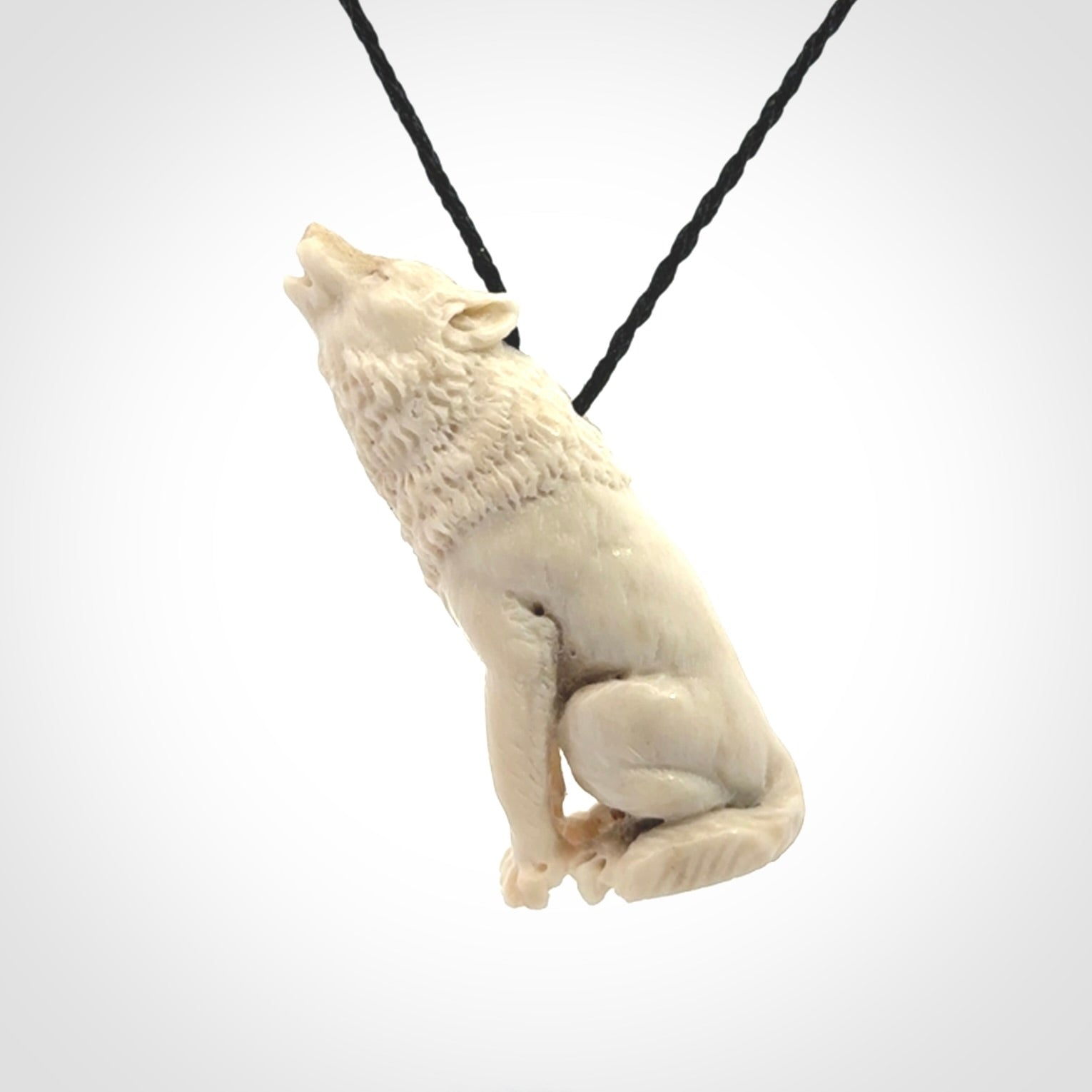 Hand carved bone wolf pendant.