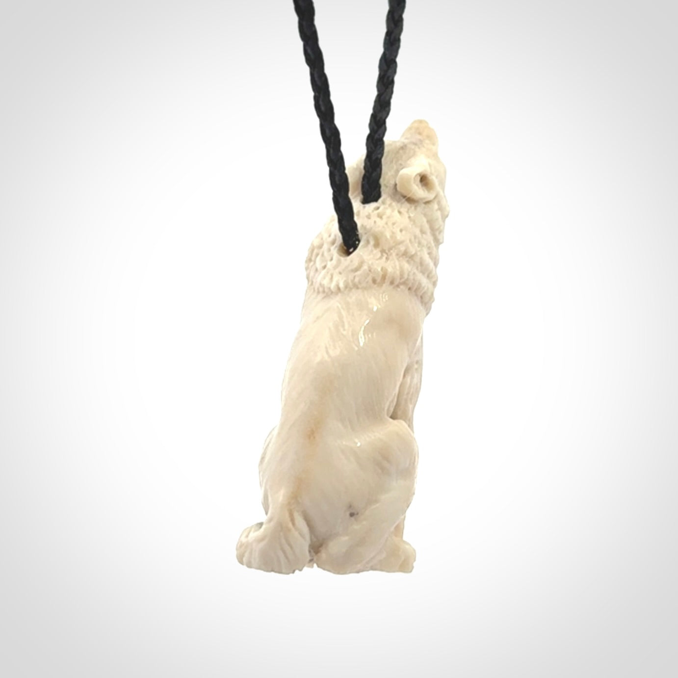 Hand carved bone wolf pendant.