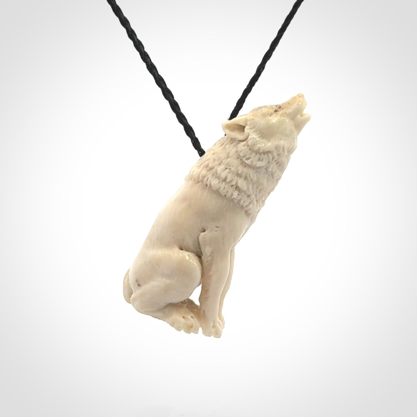 Hand carved bone wolf pendant.
