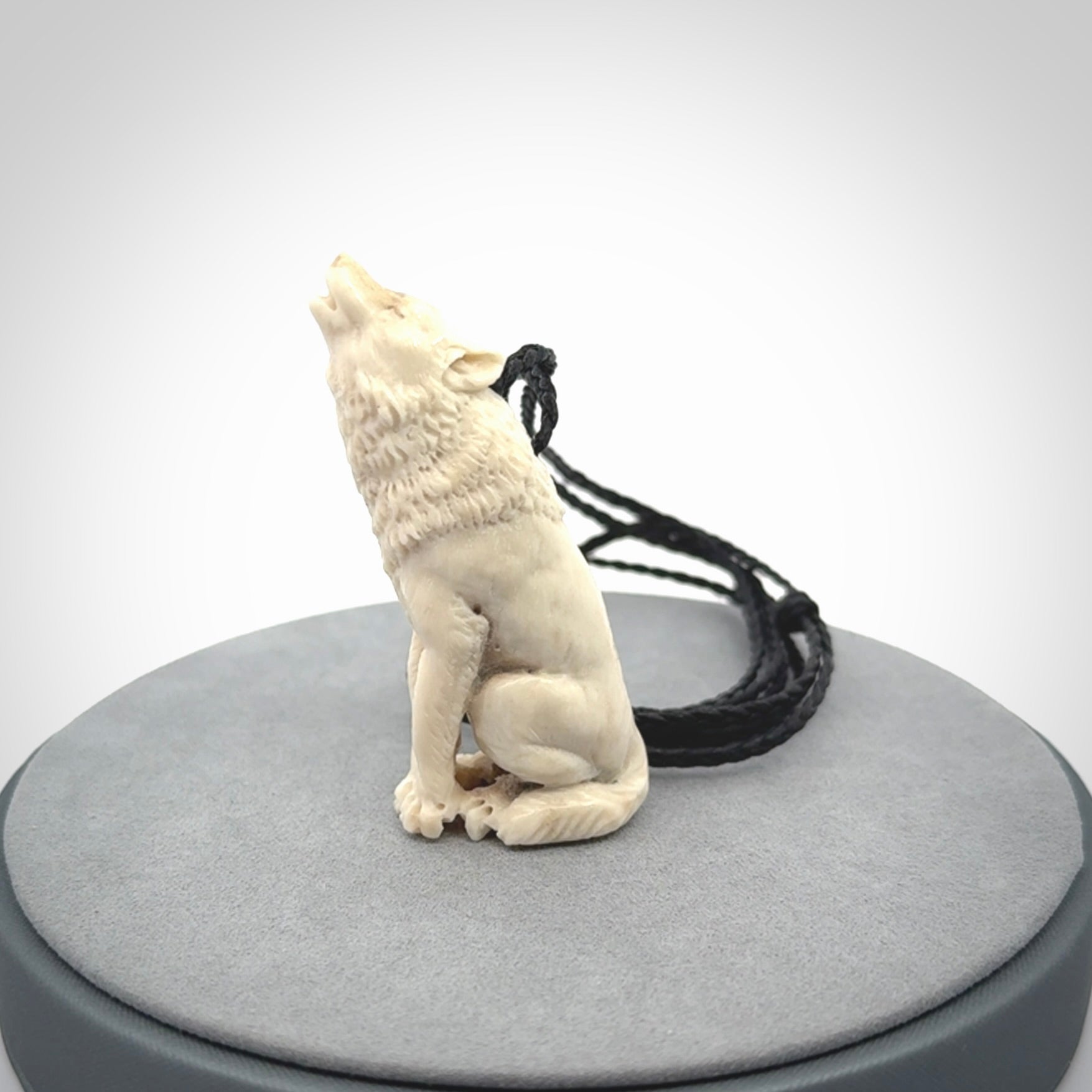 Hand carved bone wolf pendant.
