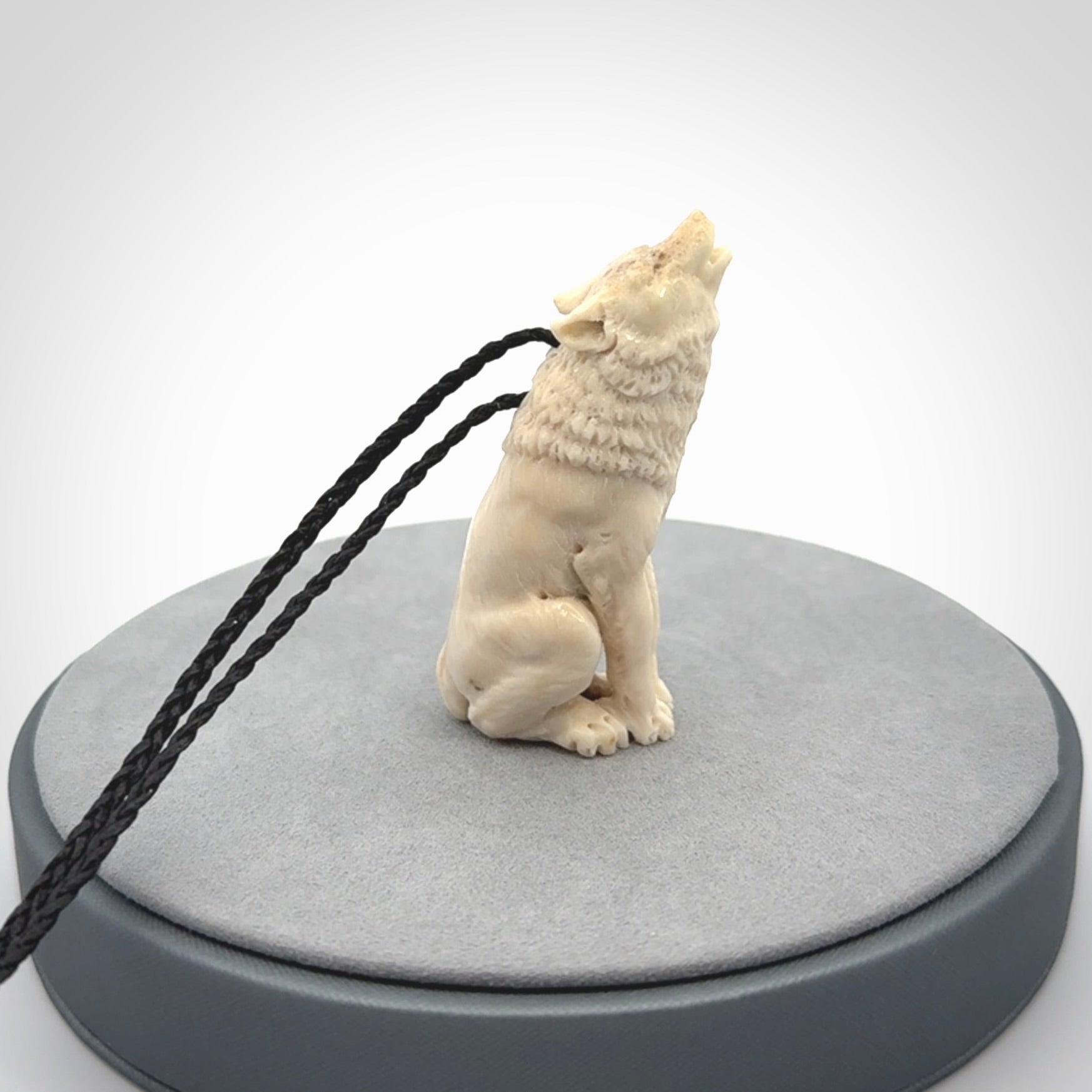 Hand carved bone wolf pendant.