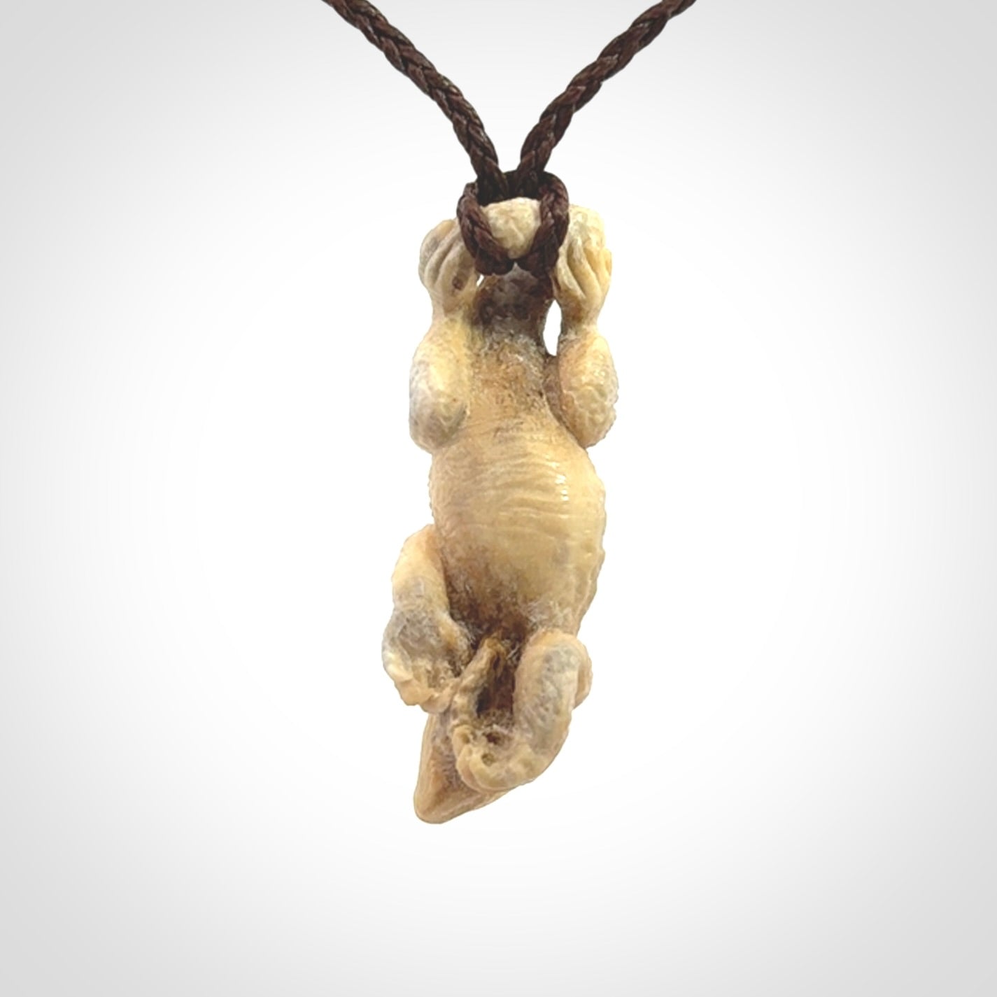 Hand carved deer antler Tuatara pendant.
