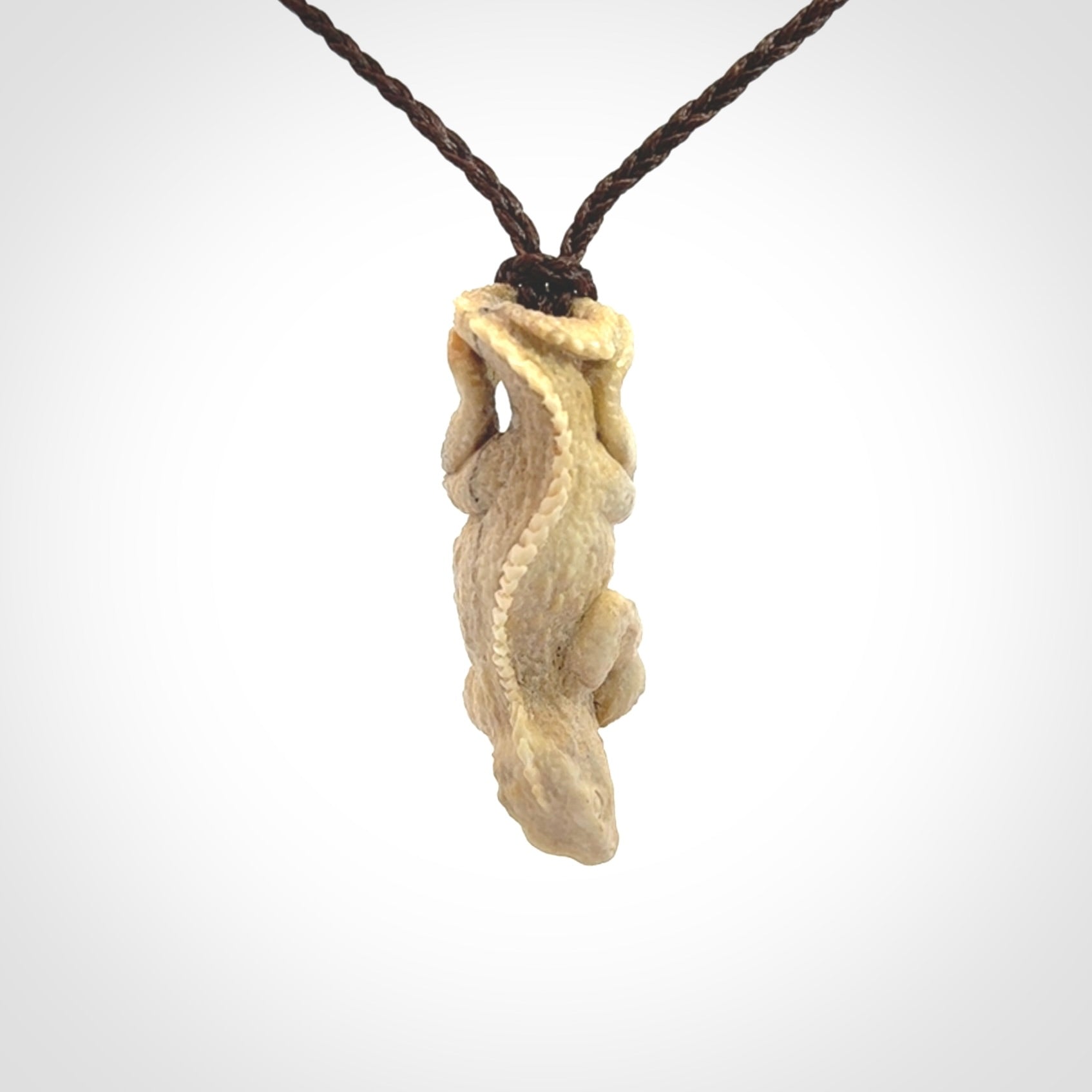 Hand carved deer antler Tuatara pendant.
