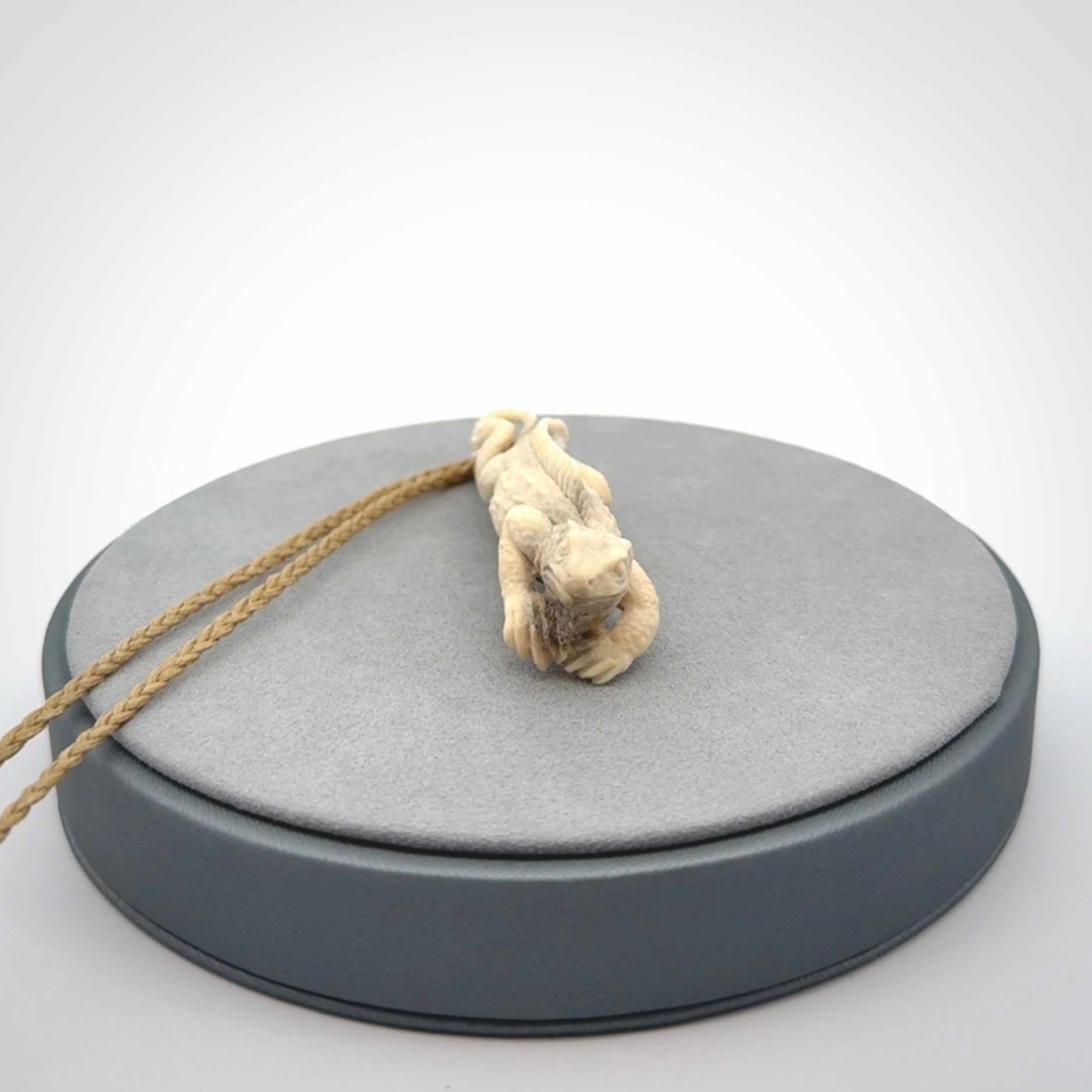 Hand carved deer antler Tuatara pendant.