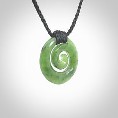 Hand carved British Columbian jade koru pendant. Delivered to you on a hand plaited black cord which is adjustable. Free delivery worldwide.