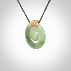 Hand carved British Columbian jade koru pendant. Delivered to you on a hand plaited manuka green cord which is adjustable. Free delivery worldwide.
