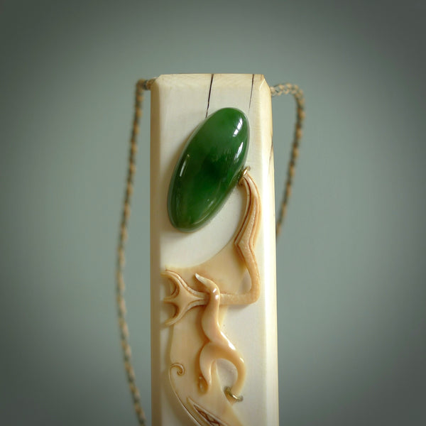 A beautiful, large toki with manaia pendant handmade from woolly mammoth tusk with Jade insert by Sami. Hand carved mammoth tusk toki manaia pendant, provided with an adjustable tan cord. Manaia head earring.