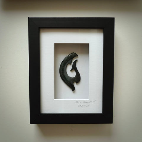 A hand carved large New Zealand Jade Koru necklace that has been framed and signed by artist Kerry Thompson. A large sized hand made koru necklace by New Zealand artist Kerry Thompson. One off framed work of art to wear. Delivered with Express Courier.