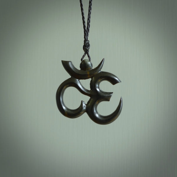 Hand carved black jade Om pendant. Carved from black jade by NZ Pacific. Unique, handmade jewellery for sale online.