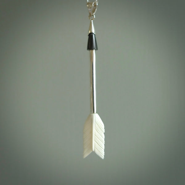 Hand carved arrow made from bone and sterling silver - this is a pendant provided with a sterling silver chain. NZ Pacific pendant for sale online. Hand made archers arrow necklace with sterling silver. One only art to wear.