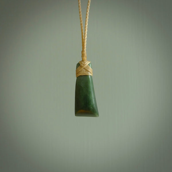 Hand carved jade toki by Ric Moor. Made in New Zealand by NZ Pacific. Hand carved Toki pendants crafted from beautiful New Zealand Pounamu, Jade. We deliver these with Express Courier, on adjustable cords.