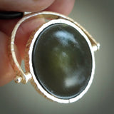 A photo of a New Zealand Jade drop pendant with sterling silver. This is a stylish statement piece - hand crafted here in New Zealand by Ana Krakosky. Unique Art to Wear. Gifts for all lovers of hand made Art to Wear. One only Fidget pendant.
