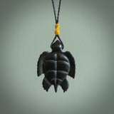 This picture shows a hand carved black jade turtle pendant. It is polished to a soft shine and has quite a lot of detail carved into the jade. The cord is a hand plaited black, waxed polyester. Carved by NZ Pacific.