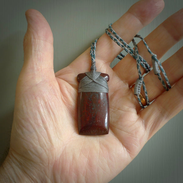 This is a beautiful hand carved Red Jasper Stone toki pendant. A really cool piece that is made from this rare and beautiful material. The red jasper has a very distinctive look and each piece is different. We ship this worldwide and the cost of shipping is included in the price.