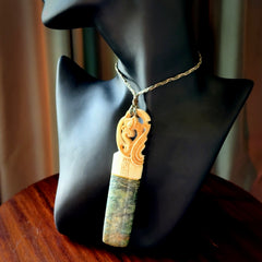 This is a large carved Manaia pendant. It is made from unique materials - New Zealand Obay Stone, Bone, Paua shell, Brass. The face of the Manaia is carved with a traditional design in the front. It is carved front and back and has traditional carved designs. This is a large and very traditional pendant that is a collectors piece.