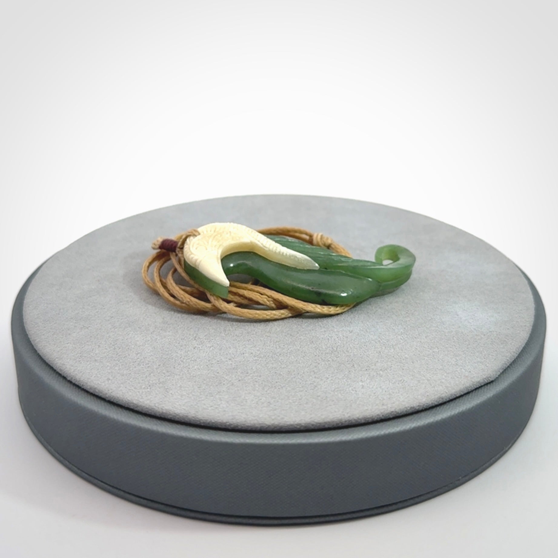 Hand carved jade and bone bird pendant