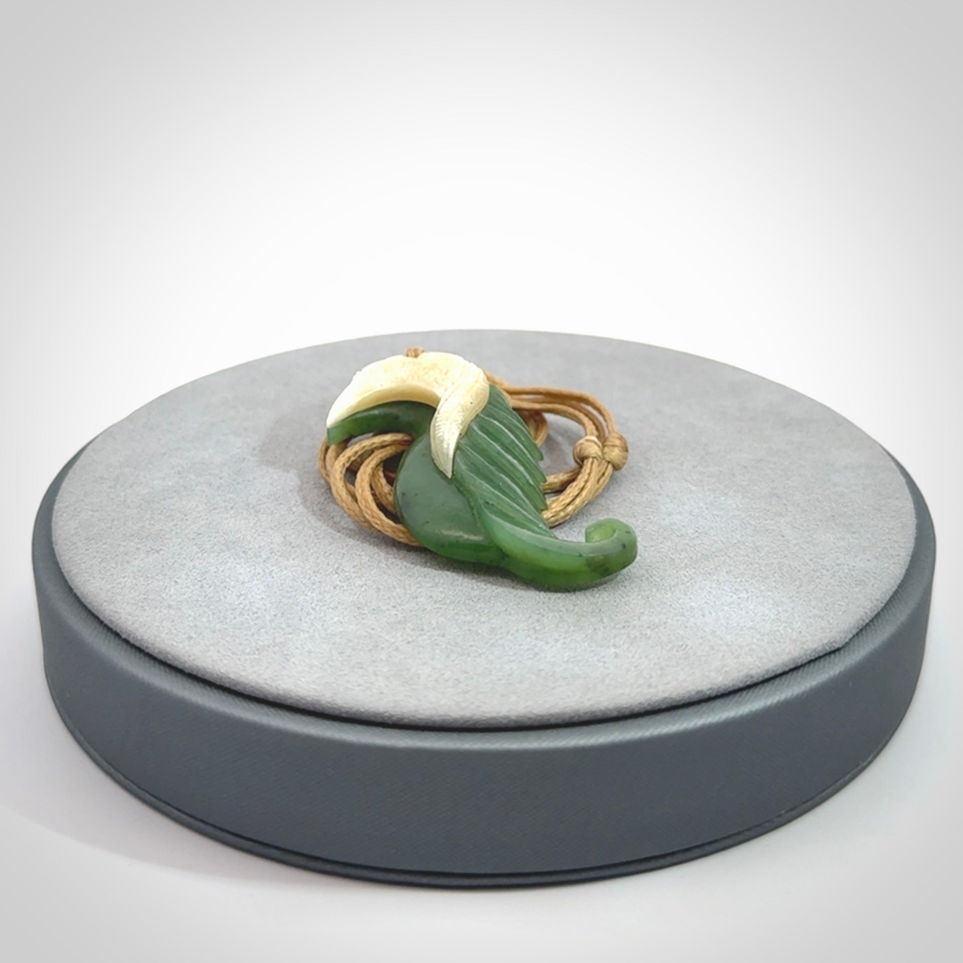 Hand carved jade and bone bird pendant